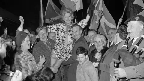 PA Media Winnie Ewing arrives in London after her victory in 1967