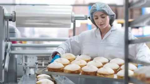 Getty Images Worker in cake factory