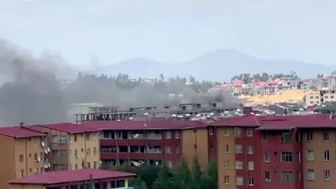 Reuters Smoke rises over Addis Ababa skyline during protests following the fatal shooting of the Ethiopian musician Hachalu Hundessa, in Addis Ababa, Ethiopia June 30, 2020, in this screengrab taken from a video