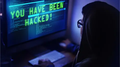 Yuri Arcurs | Getty Person looking at computer screen with the words, 'you have been hacked' on screen