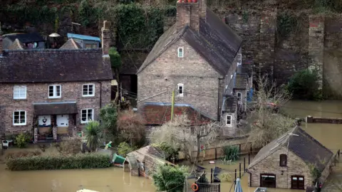 The Vic Haddock boat house (right) under water on the River Severn