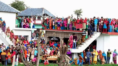 EPA Villagers gather in large numbers as body of slain Central Reserve Police Force (CRPF) soldier Tilak Raj arrives at his home in village Dhewa Jandroh, some 90km from Dharamsala