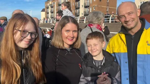 Paul and Melanie Taylor, with their two children, at the Tata Steel protest