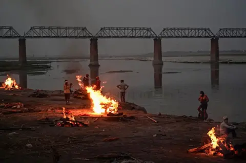 Getty Images Funeral pyres are lit by the Ganges in Allahabad - bodies have been washing up downstream for days