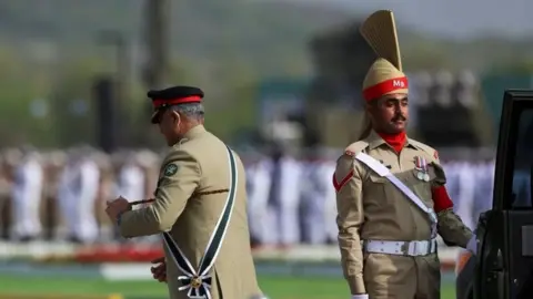 Reuters Pakistan's army Chief of Staff Gen Qamar Javed Bajwa (left) at a military parade in Islamabad. Photo: 23 March 2022