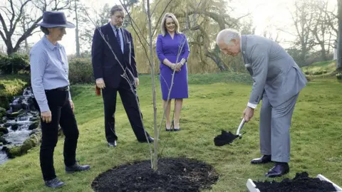 Brian Morrison/Northern Ireland Office Prince Charles planting a tree