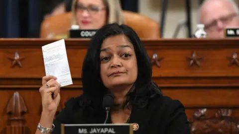 Getty Images Democratic Congresswoman Pramila Jayapal held up a copy of the US constitution as she voted