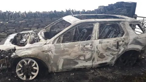 North Wales Police A burned-out Land Rover Discovery