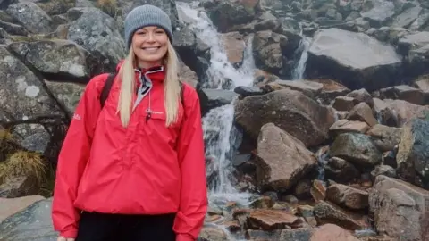 Phoebe Lenderyou  Phoebe smiling in front of a waterfall