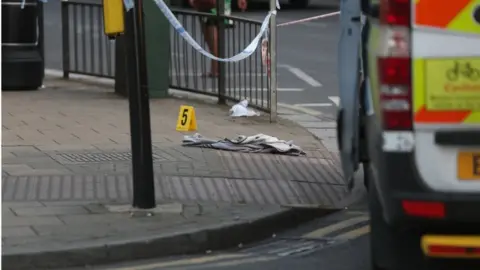 PA An item of clothing lies on the pavement at the junction of Palmerston Road and Wealdstone High Street