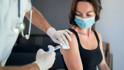 Getty Images woman getting her vaccine