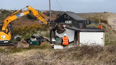 Demolition of wooden home on Hemsby dunes