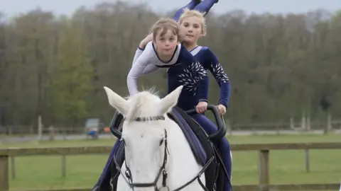 BBC Two girls on horseback practising vaulting