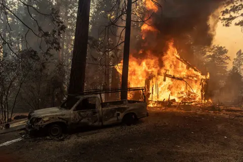 Carlos Barria / Reuters A house is on fire as the Oak Fire burns near Darrah in Mariposa County, California, US., on 23 July 2022