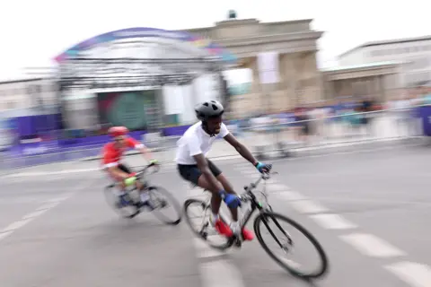 Alexander Hassenstein/Getty Images Kennedy Munyao (R) of Kenya competes with Odai Deirawan of Syria at the Brandenburg Gate during day nine of Special Olympics World Games Berlin 2023 in Berlin Germany - Sunday 25 June 2023