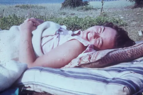 1968 CRD253 Group Wendy Scott lying on a mattress on the beach by the Black Sea