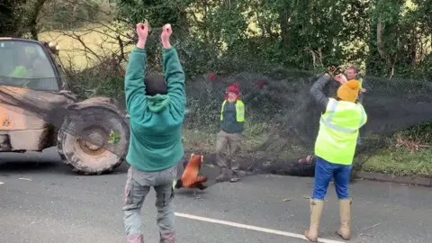 Volunteers and staff catching the panda in a net