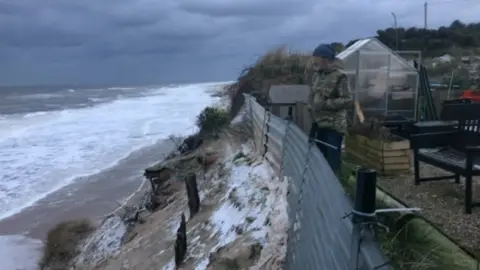 Lance Martin looks out to sea from his garden