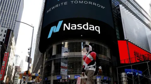 Getty Images Tesla and Apple stocks tumble dragging down the tech-heavy Nasdaq index.