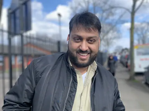 KATEMCGOUGH/BBC Father outside school