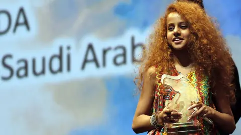 Getty Images Saudi Actress Waad Mohammed accepts the Muhr Arab Feature award (Best Actress) for her film Wadjda