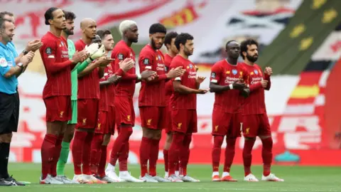 Getty Images Liverpool FC players applaud key workers