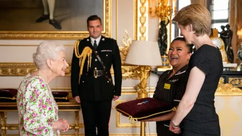 Reuters The Queen speaking to NHS England chief executive Amanda Pritchard and May Parsons