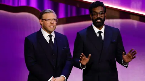 Getty Images Rob Beckett and Romesh Ranganathan speak onstage during the 2024 BAFTA Television Awards