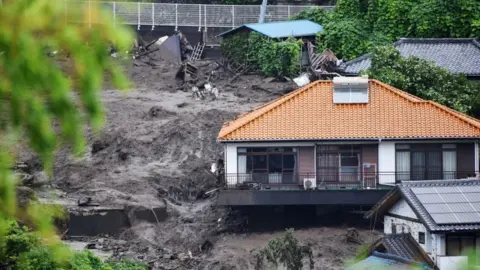 Homes destroyed by mudslide triggered by torrential rain in Atami, Japan.