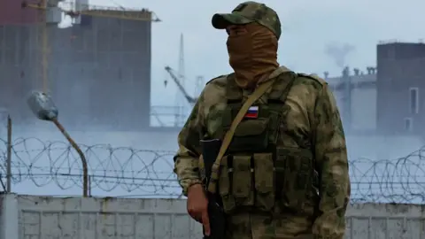 Reuters A Russia soldier outside the Zaporizhzhia Nuclear Power Plant