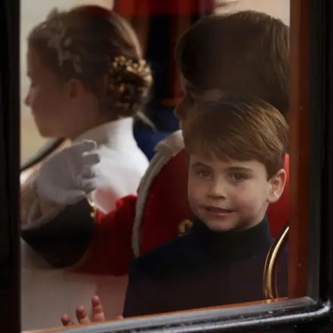 Reuters Prince Louis with his brother Prince George and sister Princess Charlotte waving from a carriage as they leave the Coronation