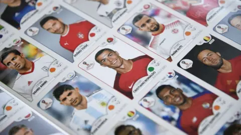 Getty Images Portugal's forward Cristiano Ronaldo among other stickers of football players for the 2018 World Cup in Russia