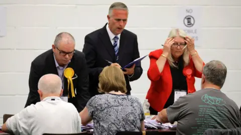 Kevin Coombs/REUTERS Party activists observe ballots being tallied at a counting centre for Britain's general election in Hastings, 8 June 2017.