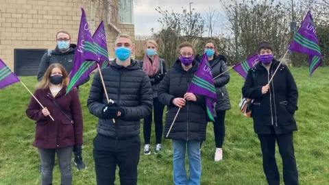 Striking union members holding flags