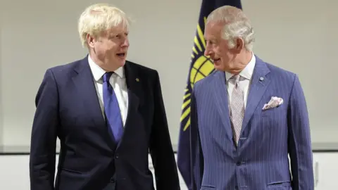 PA Media Boris Johnson and Prince Charles stand side by side in conversation with one another