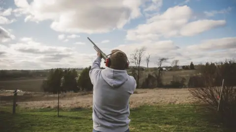 Man doing clay pigeon shooting