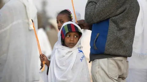 AFP A young boy holds a candle during the Timket, an Epiphany festival, in Addis Ababa, on January 19, 2018.