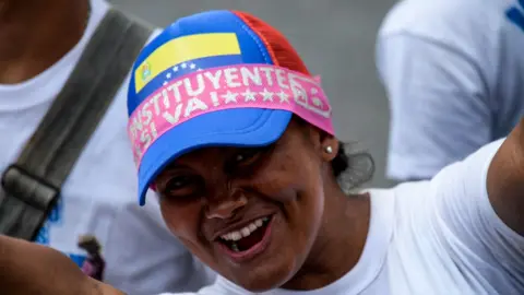 Getty Images A supporter of Venezuelan President Nicolas Maduro cheers during the closing of the campaign to elect the members of a Constituent Assembly that would rewrite the constitution, in Caracas on July 27, 2017