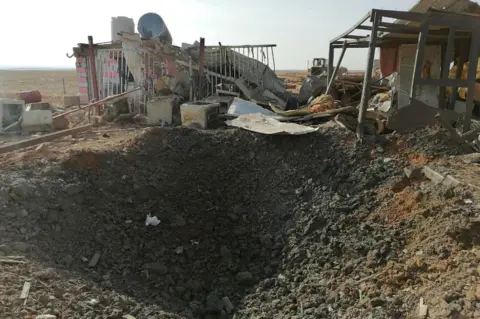 Reuters A hole left after an air strike at the headquarters of the Kataib Hezbollah militia group in Qaim, Iraq, on 30 December 2019
