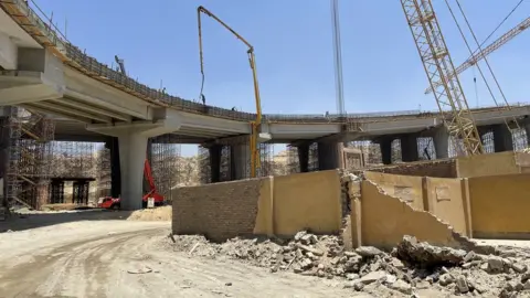 Demolished tombs next to a flyover being built in Historic Cairo