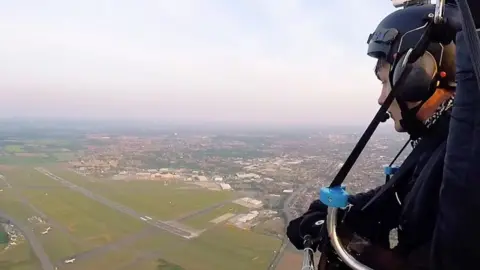 Dan Jones flying over Norwich Airport