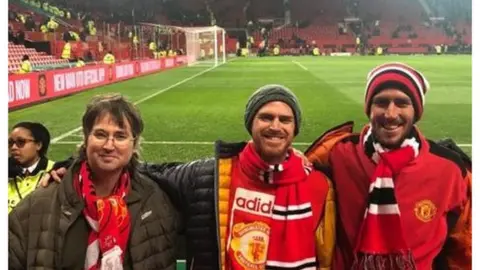 Yoni, in the middle, at Old Trafford with friends