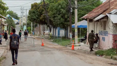 Ben Toren Police and soldiers man a checkpoint in Denham Town
