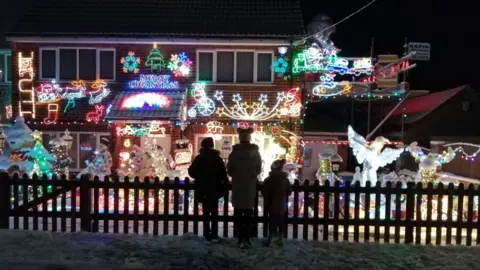 Amy Tall Children in front of decorated house