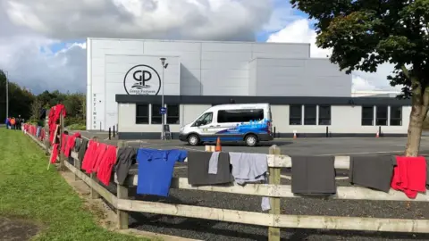 Protesters left their work shirts attached to the fence around Green Pastures