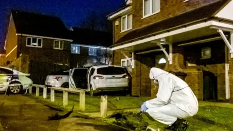 SWNS Forensics officer at scene of crashed car