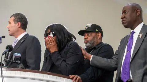 Getty Images The mother of Tyre Nichols, second from left, at a press conference after she viewed footage encounter that led to her son's death. Also pictured from left: attorney Antonio Romanucci, husband Rodney Wells, and attorney Ben Crump