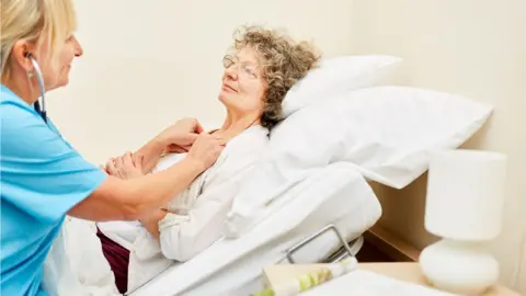 Getty Images Carer and patient