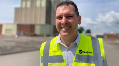 Berkeley site director Chris Burden wearing a hi vis jacket smiling into the camera