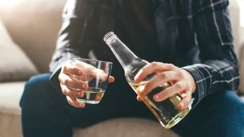 Getty Images Man at home with beer